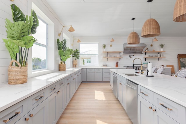 kitchen featuring dishwasher, plenty of natural light, hanging light fixtures, and light stone counters