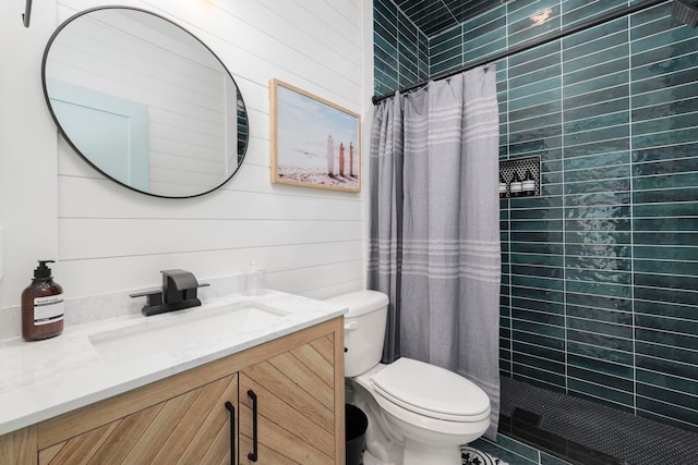 bathroom with a shower with curtain, wooden walls, vanity, and toilet