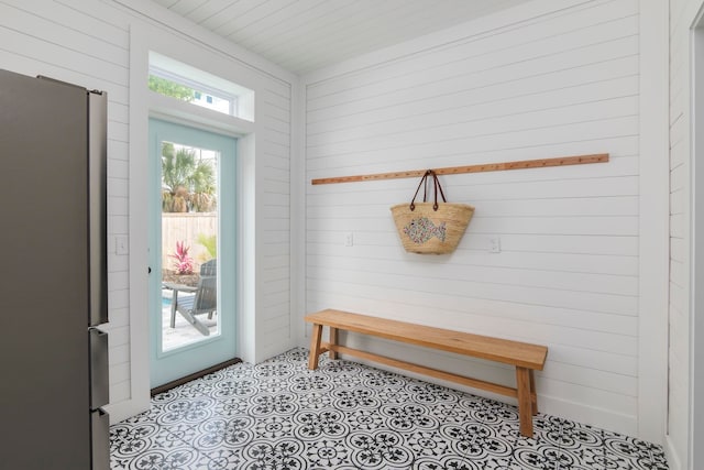 mudroom with wooden walls