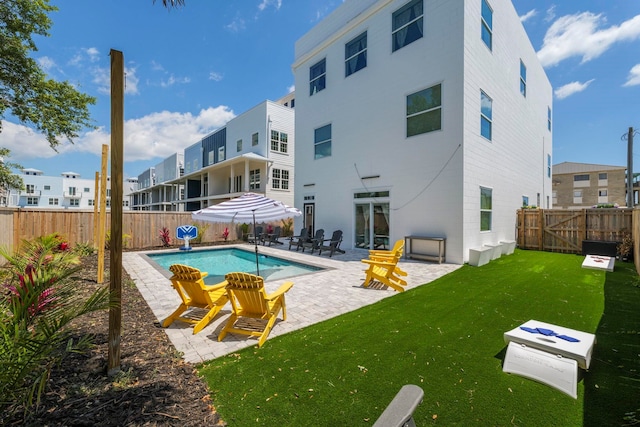 view of pool with a patio area and a yard