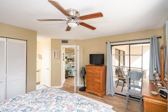 bedroom featuring a textured ceiling, a closet, light hardwood / wood-style flooring, and ceiling fan