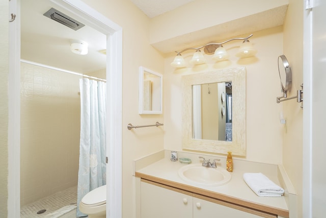 bathroom featuring vanity, toilet, and walk in shower