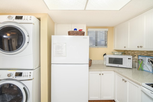 washroom with stacked washing maching and dryer