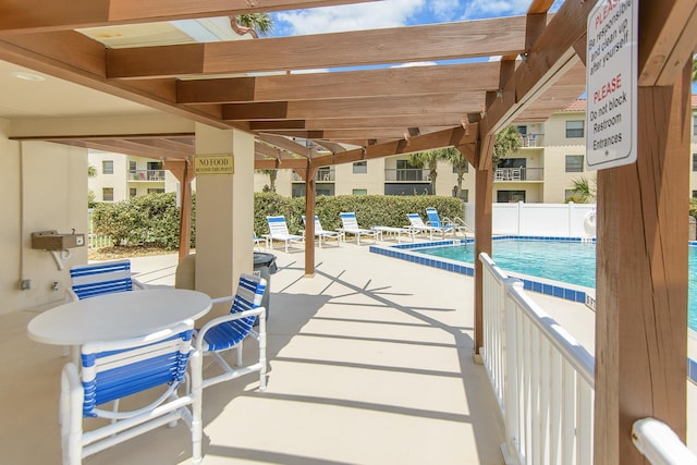 view of swimming pool with a pergola and a patio