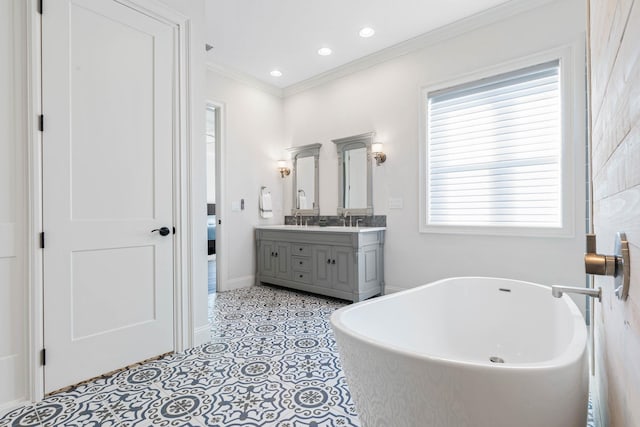 bathroom featuring a tub to relax in, vanity, tile patterned flooring, and crown molding