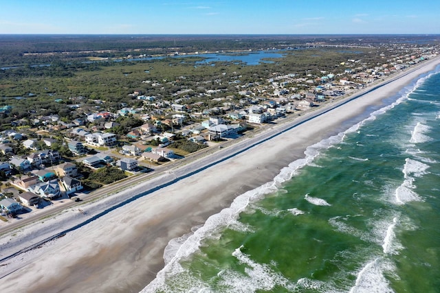 birds eye view of property with a beach view and a water view