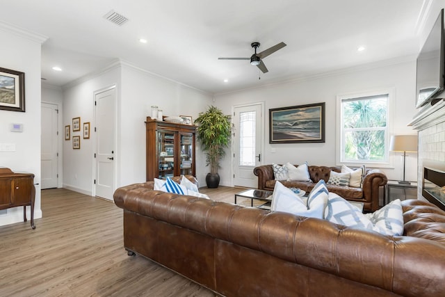 living room with ceiling fan, a healthy amount of sunlight, and light hardwood / wood-style floors