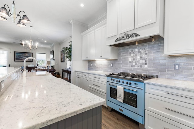 kitchen featuring range with gas cooktop, tasteful backsplash, hanging light fixtures, light stone countertops, and white cabinets