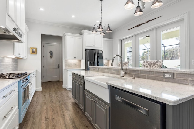 kitchen featuring backsplash, white cabinets, and stainless steel appliances