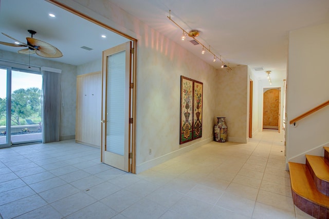 4 Oceanside Dr, Saint Augustine Beach, FL 32080 - empty room with a ceiling fan, stairway, light tile patterned flooring, recessed lighting, and rail lighting
