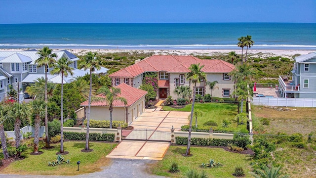 4 Oceanside Dr, Saint Augustine Beach, FL 32080 - view of front of house with driveway, view of water and beach, a tiled roof, and stucco siding