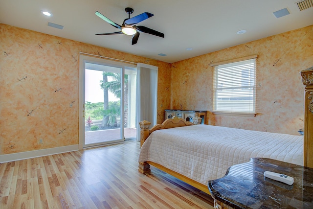 4 Oceanside Dr, Saint Augustine Beach, FL 32080 - bedroom with access to exterior, wood finished floors, wallpapered walls, and a ceiling fan