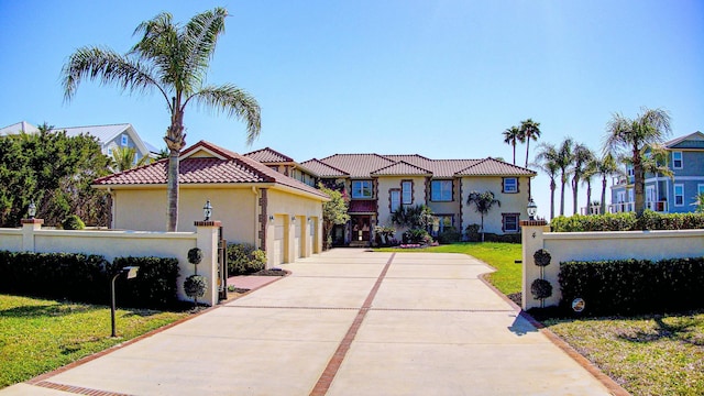 4 Oceanside Dr, Saint Augustine Beach, FL 32080 - mediterranean / spanish home featuring concrete driveway, stucco siding, a garage, and a tiled roof