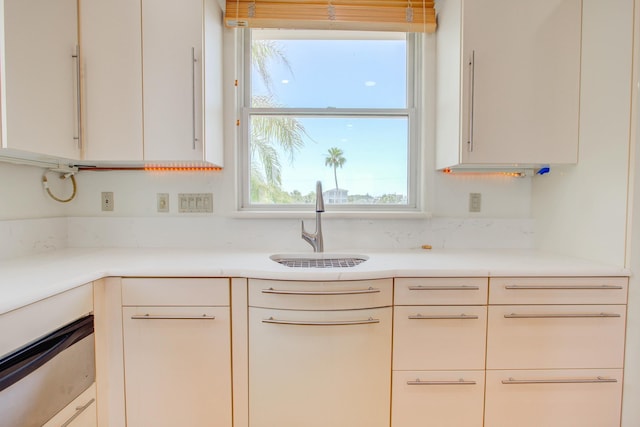 4 Oceanside Dr, Saint Augustine Beach, FL 32080 - kitchen with a sink, light countertops, and white cabinets