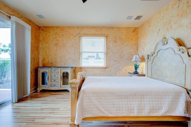4 Oceanside Dr, Saint Augustine Beach, FL 32080 - bedroom with wood finished floors, access to outside, and wallpapered walls
