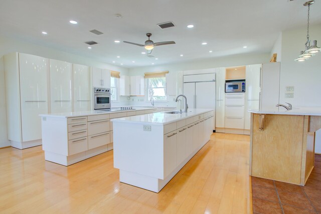 4 Oceanside Dr, Saint Augustine Beach, FL 32080 - kitchen with built in appliances, a large island, ceiling fan, light countertops, and recessed lighting