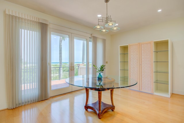 4 Oceanside Dr, Saint Augustine Beach, FL 32080 - dining area featuring french doors, light wood-style flooring, recessed lighting, and a chandelier