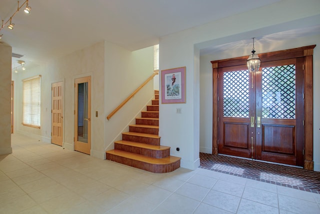 4 Oceanside Dr, Saint Augustine Beach, FL 32080 - tiled entrance foyer featuring stairs and baseboards