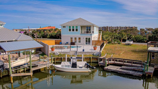 view of dock with boat lift, a balcony, a water view, fence, and an outdoor pool