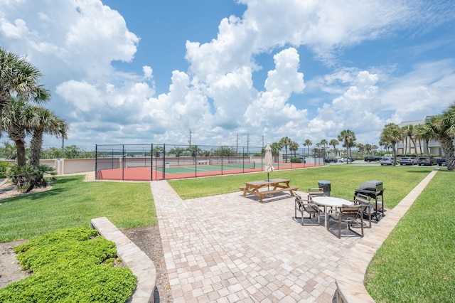 7780 S A1A Unit 101, Saint Augustine, FL 32080 - view of patio / terrace with a tennis court and area for grilling