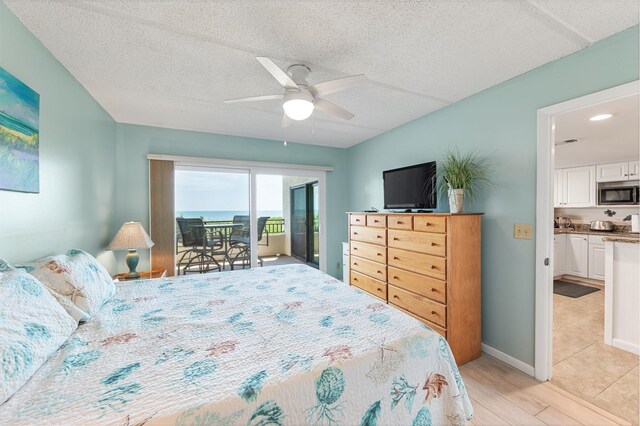 7780 S A1A Unit 101, Saint Augustine, FL 32080 - bedroom featuring access to exterior, light wood finished floors, and a ceiling fan
