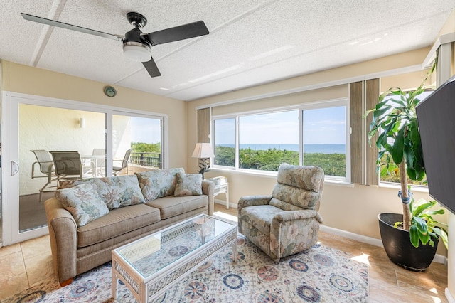 7780 S A1A Unit 101, Saint Augustine, FL 32080 - living area with a ceiling fan, a textured ceiling, and light tile patterned floors