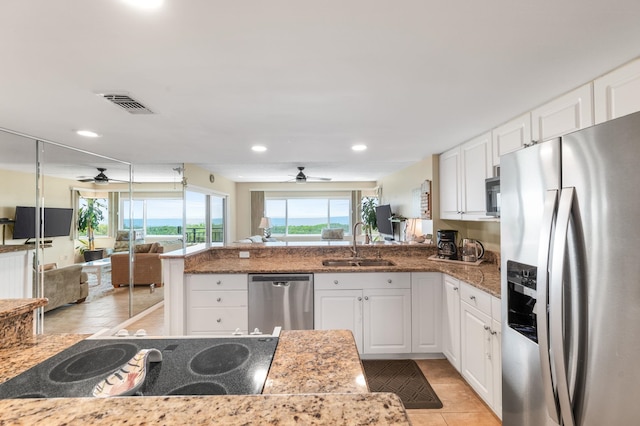 7780 S A1A Unit 101, Saint Augustine, FL 32080 - kitchen with stainless steel appliances, a ceiling fan, open floor plan, a peninsula, and recessed lighting