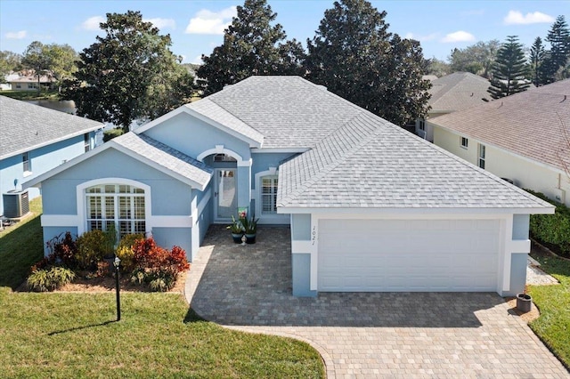 1021 Windward Way, Saint Augustine, FL 32080 - ranch-style house featuring roof with shingles, stucco siding, a garage, a front lawn, and driveway