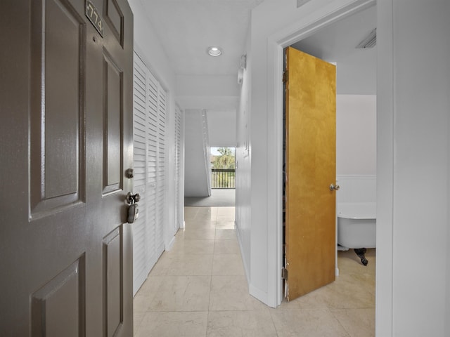 hallway featuring light tile patterned floors