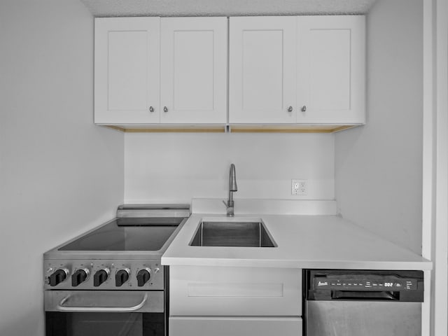 kitchen with dishwasher, stainless steel electric range, light countertops, white cabinetry, and a sink