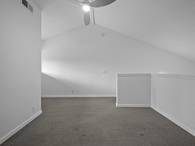 additional living space featuring ceiling fan, carpet flooring, visible vents, baseboards, and vaulted ceiling