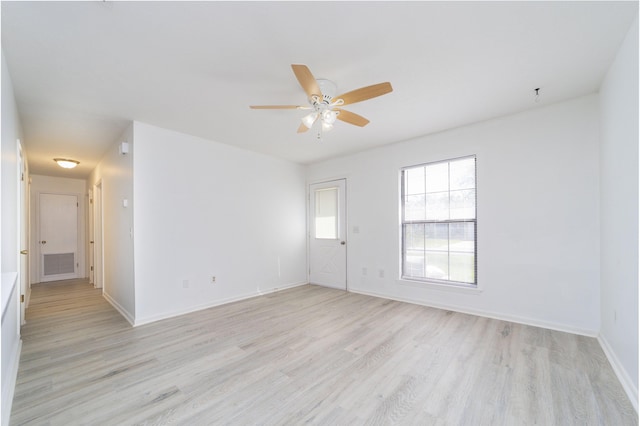 empty room with ceiling fan and light hardwood / wood-style flooring