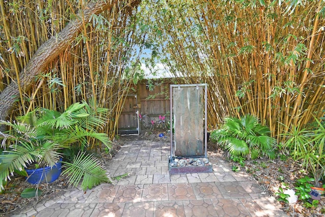 123 Whispering Oaks Cir, Saint Augustine, FL 32080 - back of property featuring a sunroom, a patio, stucco siding, and roof with shingles