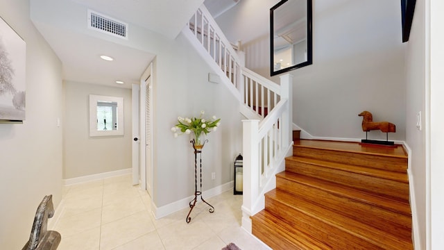 stairway with tile patterned floors