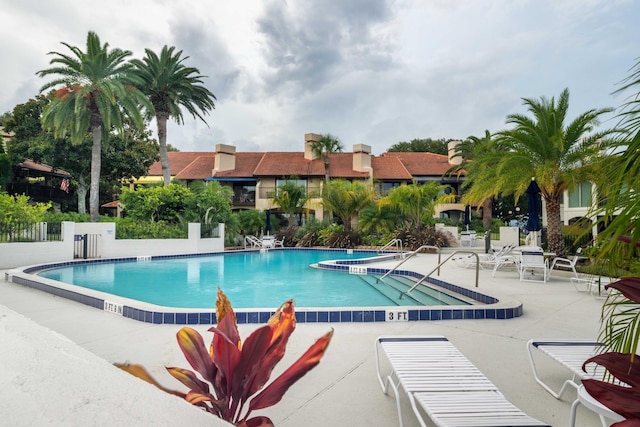 view of swimming pool featuring a patio area