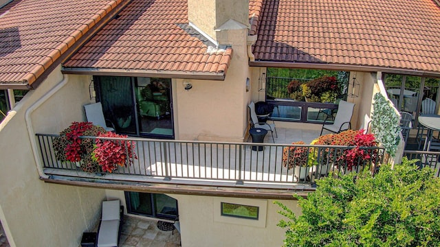 view of side of home with a balcony