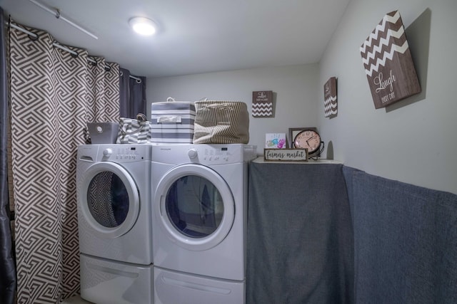 clothes washing area with washing machine and dryer