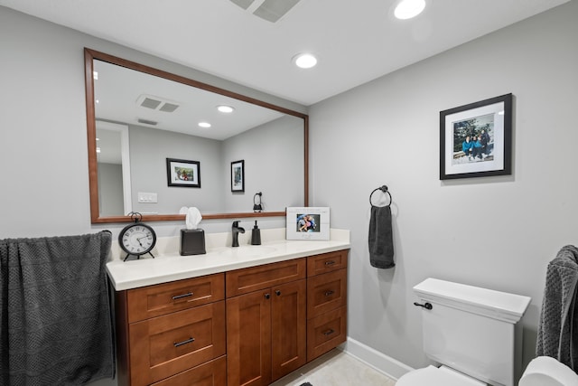 bathroom featuring vanity and toilet