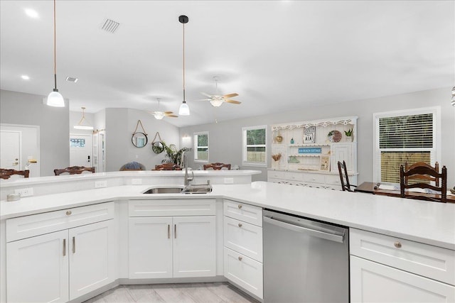 kitchen with dishwasher, open floor plan, hanging light fixtures, light countertops, and a sink