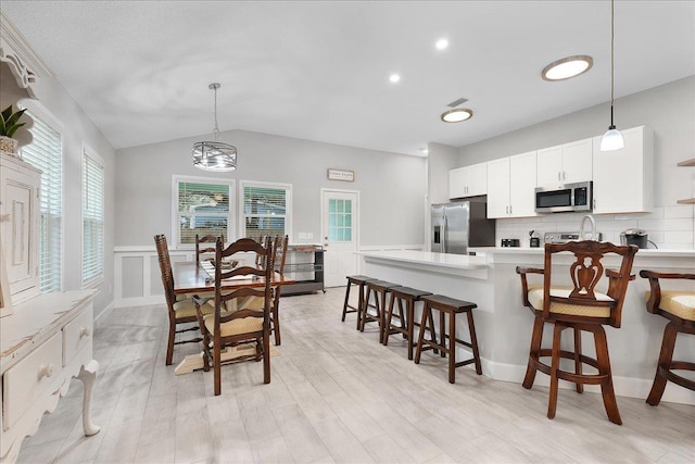 kitchen featuring open shelves, stainless steel appliances, light countertops, hanging light fixtures, and white cabinets