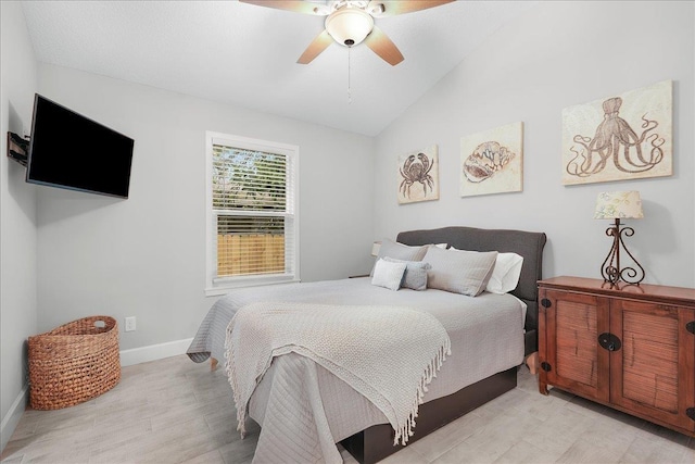 bedroom with lofted ceiling, ceiling fan, light wood finished floors, and baseboards