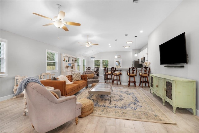 living room with a ceiling fan, light wood-type flooring, lofted ceiling, and baseboards