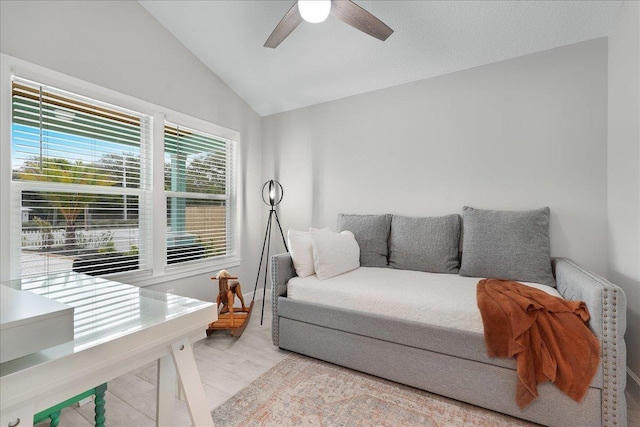 interior space with vaulted ceiling, ceiling fan, and baseboards