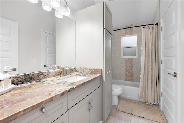 bathroom with toilet, tile patterned flooring, shower / bath combination with curtain, and vanity