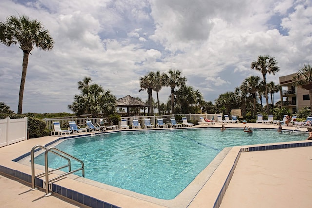 community pool featuring a patio, fence, and a gazebo