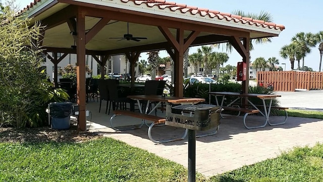 view of patio / terrace with a ceiling fan, a gazebo, and fence