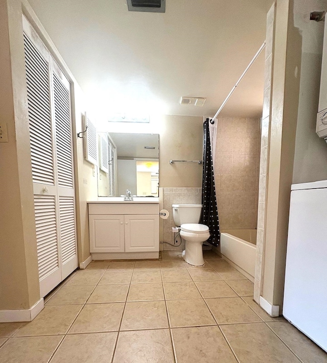 full bath with toilet, vanity, shower / tub combo with curtain, visible vents, and tile patterned flooring