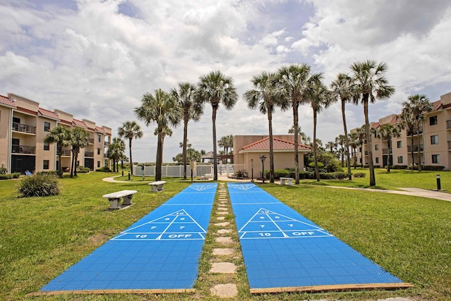 view of property's community with a residential view, shuffleboard, and a lawn