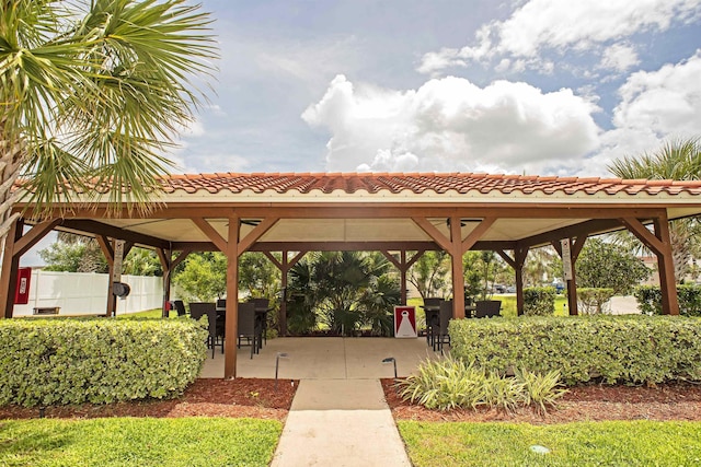 view of community featuring a gazebo, fence, and a patio area