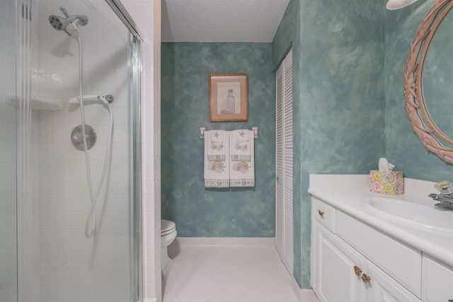 bathroom featuring vanity, a shower with door, tile patterned flooring, toilet, and a textured ceiling